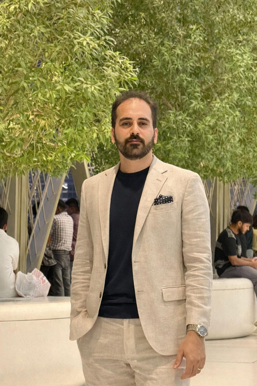 Amir Mehrabi in a beige suit